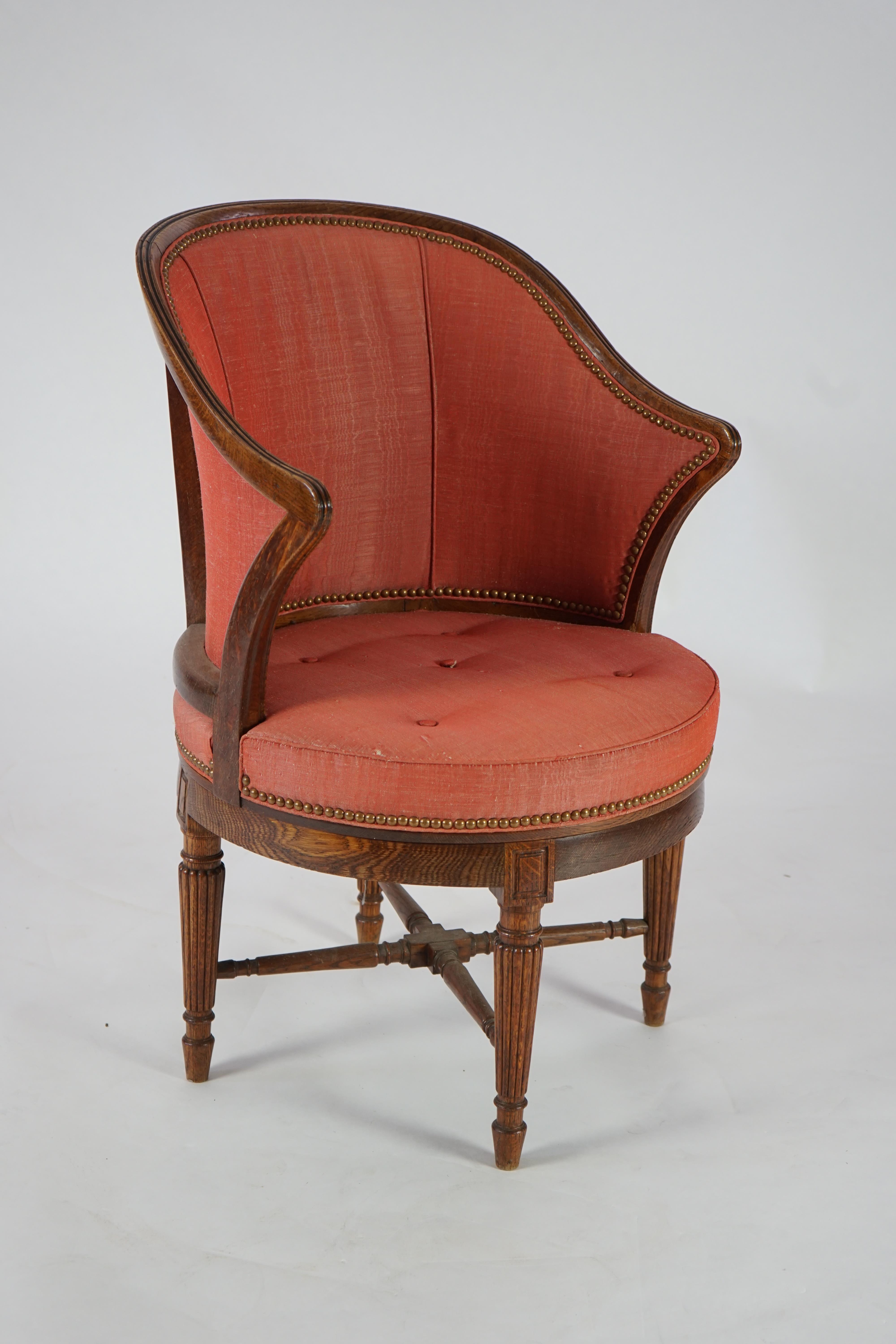 An unusual late Victorian oak revolving desk chair by Waring & Sons